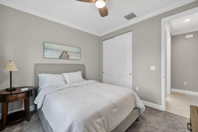 a spacious bedroom with a large bed and a chandelier