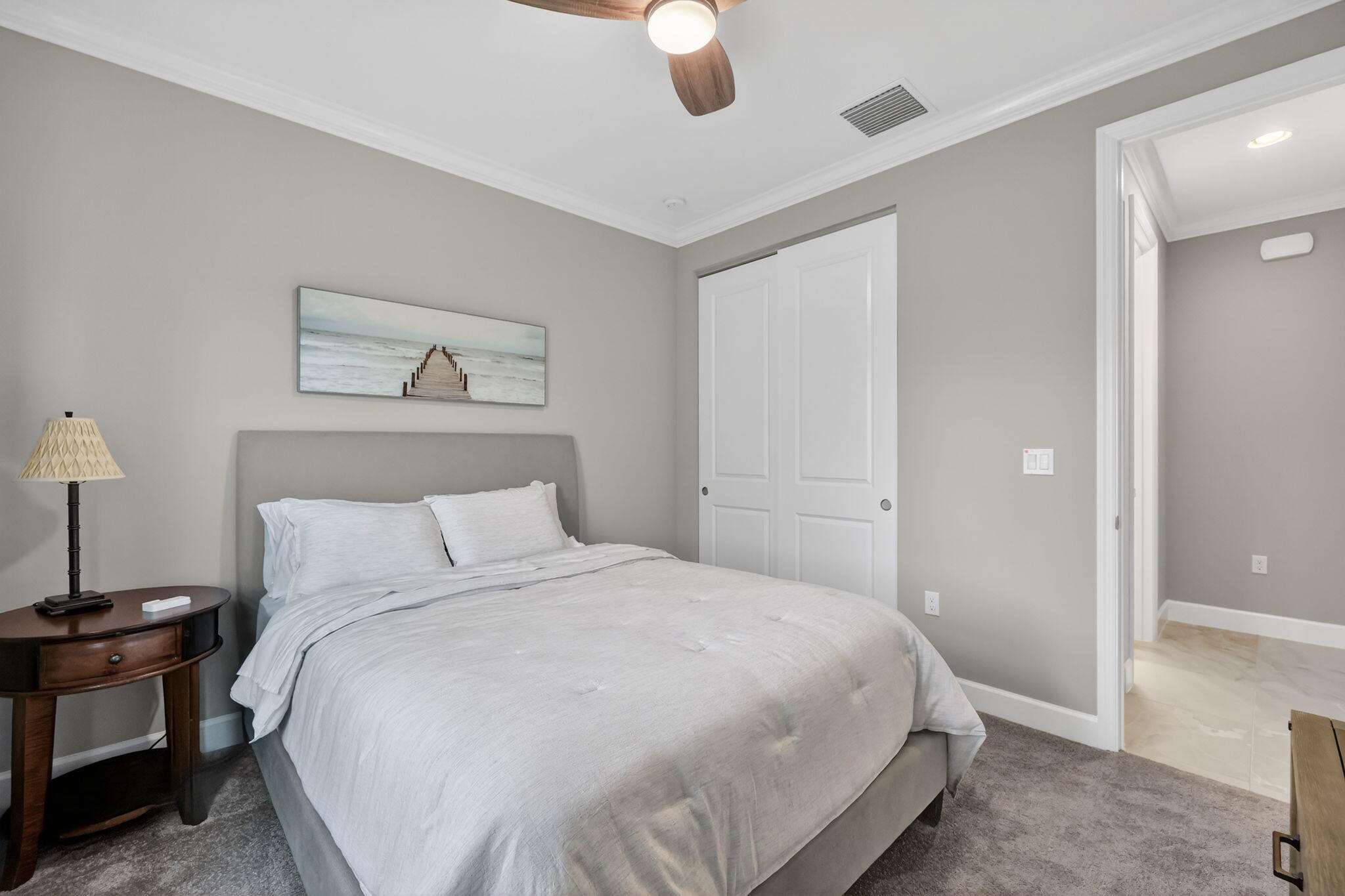 12447 Southwest Blue Mangrove Parkway Port St. Lucie, FL 34987 - Photo 17 of 80 a bedroom with a bed and a painting on the wall