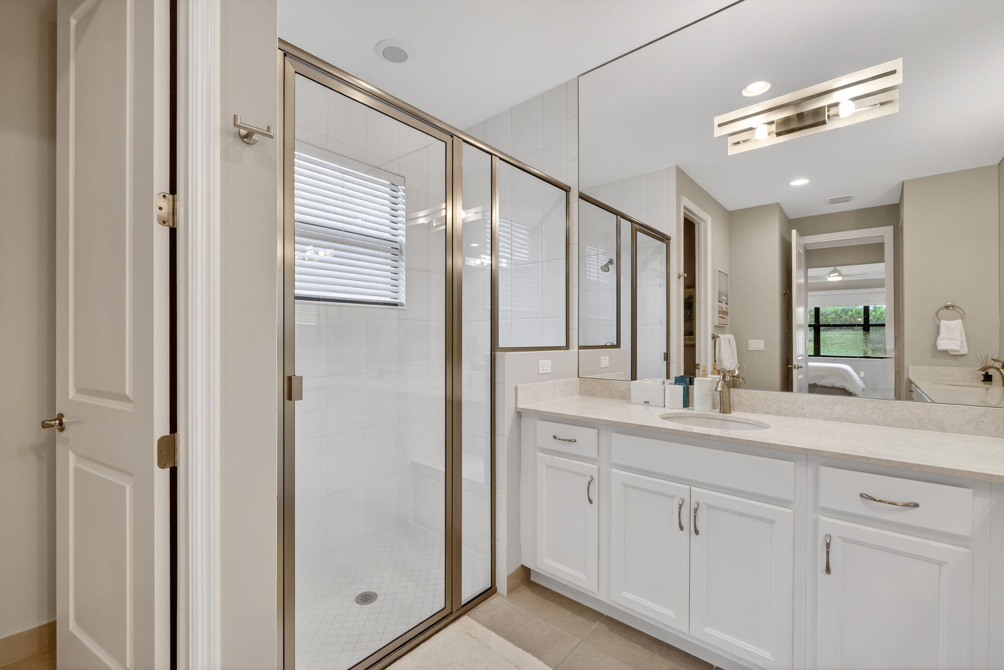 12447 Southwest Blue Mangrove Parkway Port St. Lucie, FL 34987 - Photo 26 of 80 a bathroom with a double vanity sink mirror and double