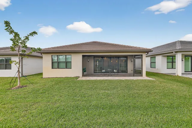 a living room with stainless steel appliances kitchen island granite countertop a large window