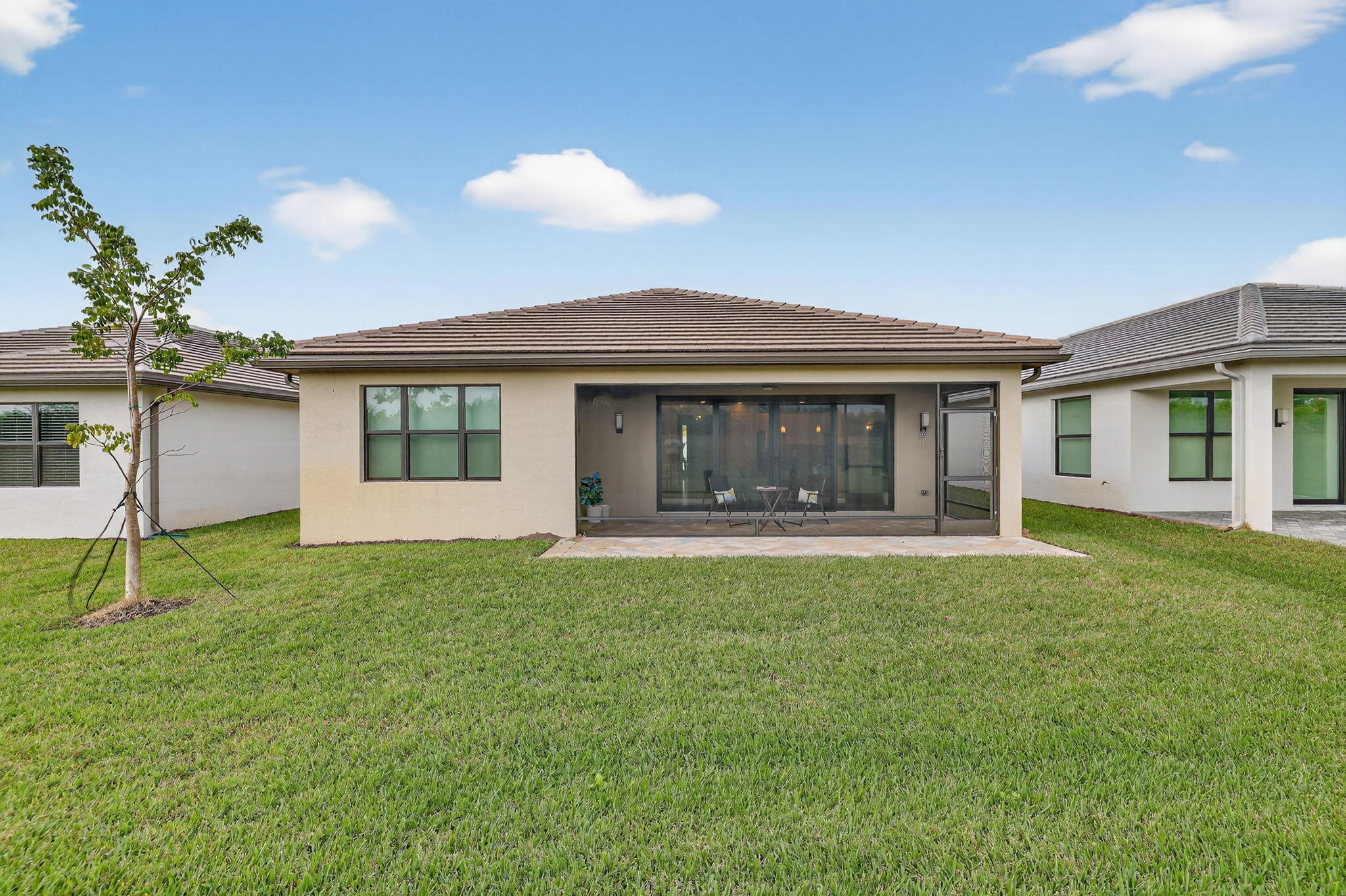 12447 Southwest Blue Mangrove Parkway Port St. Lucie, FL 34987 - Photo 32 of 80 a front view of house with yard and outdoor seating