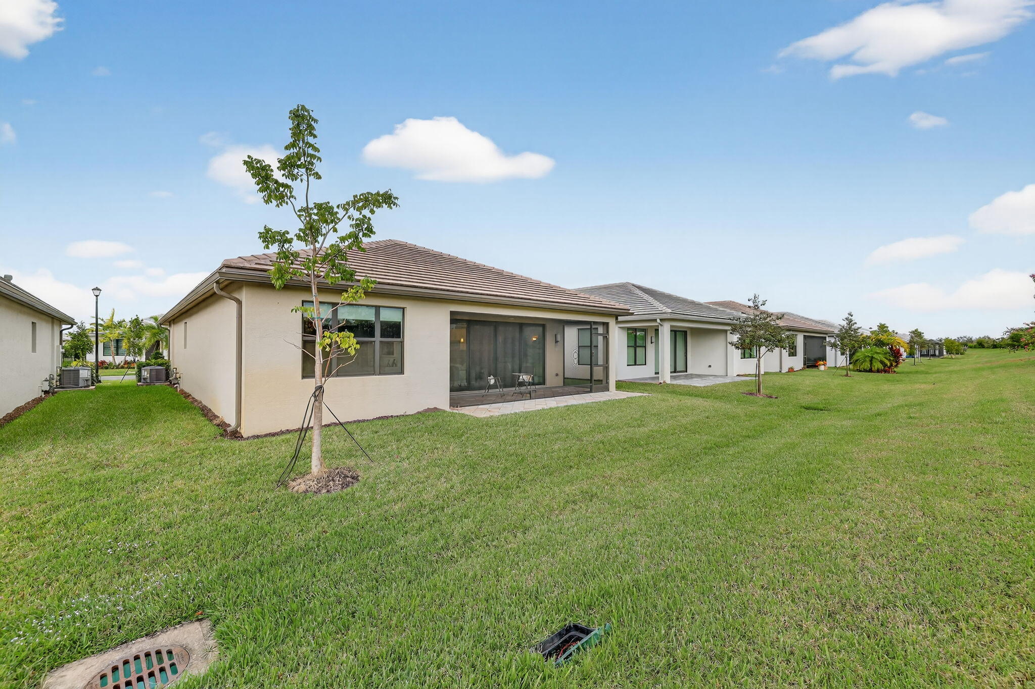 12447 Southwest Blue Mangrove Parkway Port St. Lucie, FL 34987 - Photo 33 of 80 a front view of a house with a garden