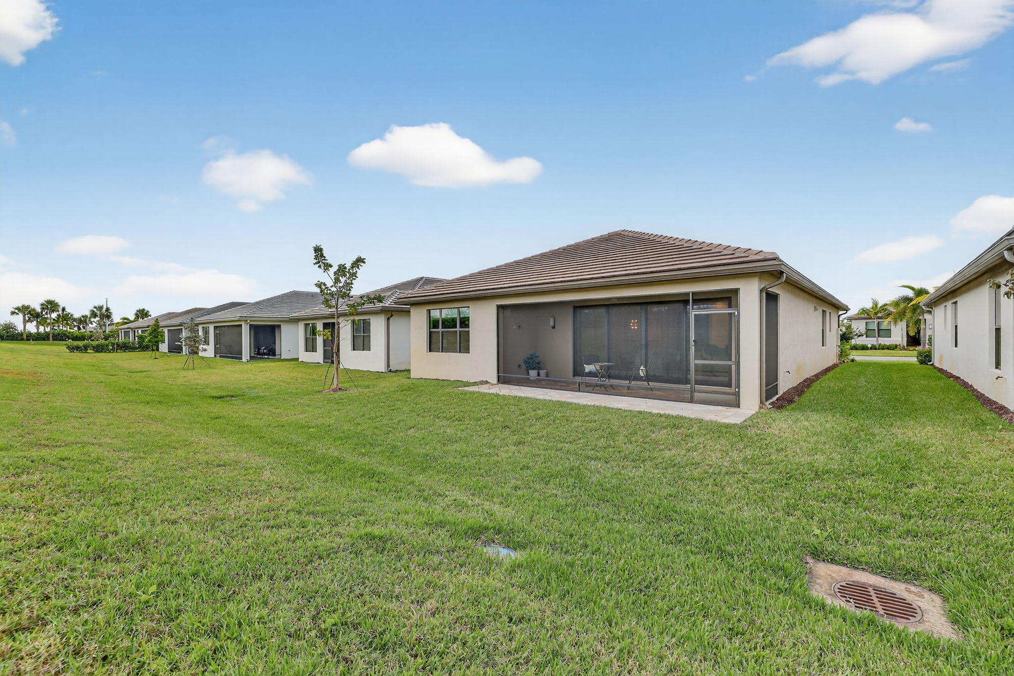 12447 Southwest Blue Mangrove Parkway Port St. Lucie, FL 34987 - Photo 35 of 80 a front view of a house with a garden