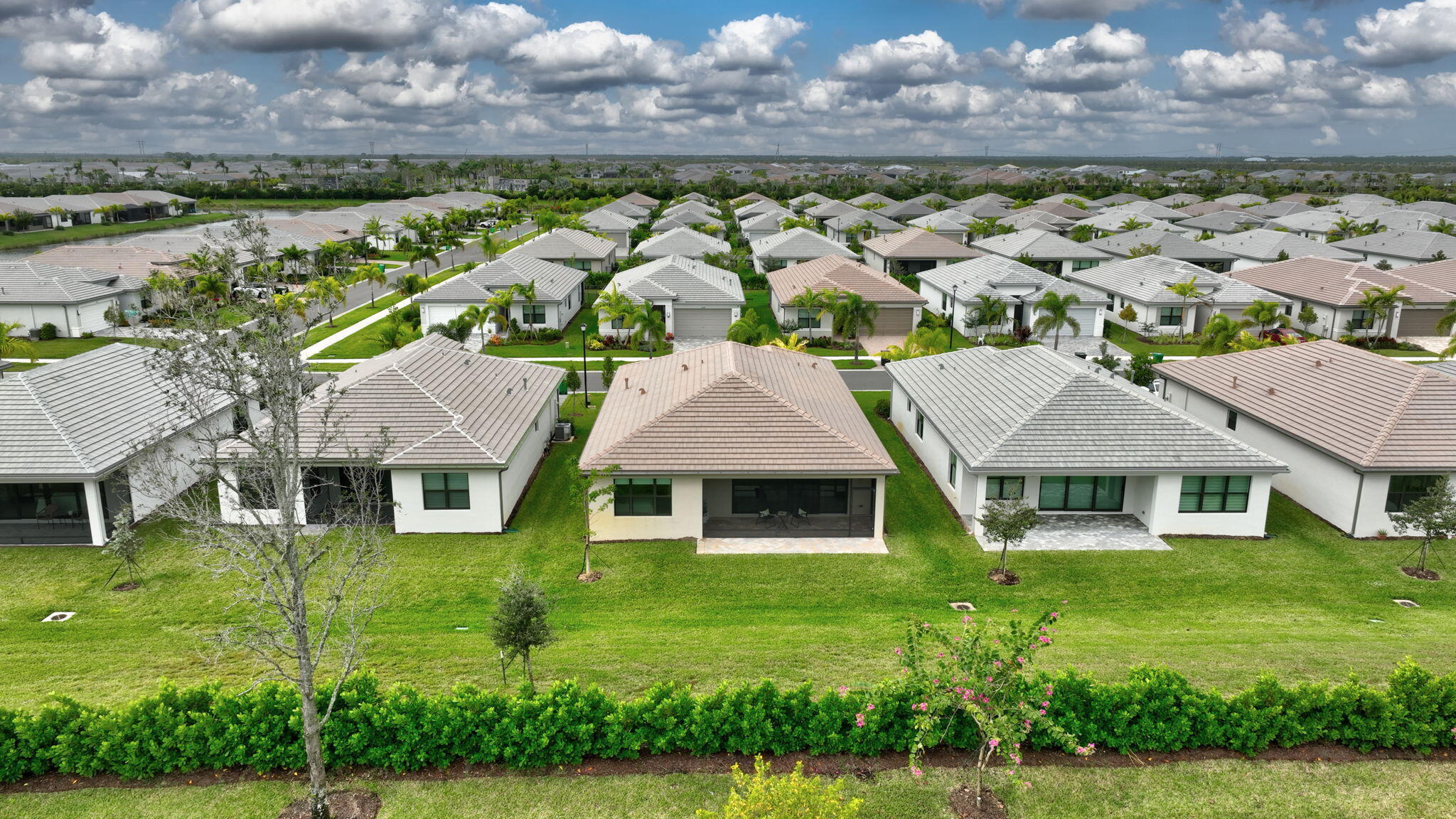 12447 Southwest Blue Mangrove Parkway Port St. Lucie, FL 34987 - Photo 43 of 80 a front view of a house with a garden