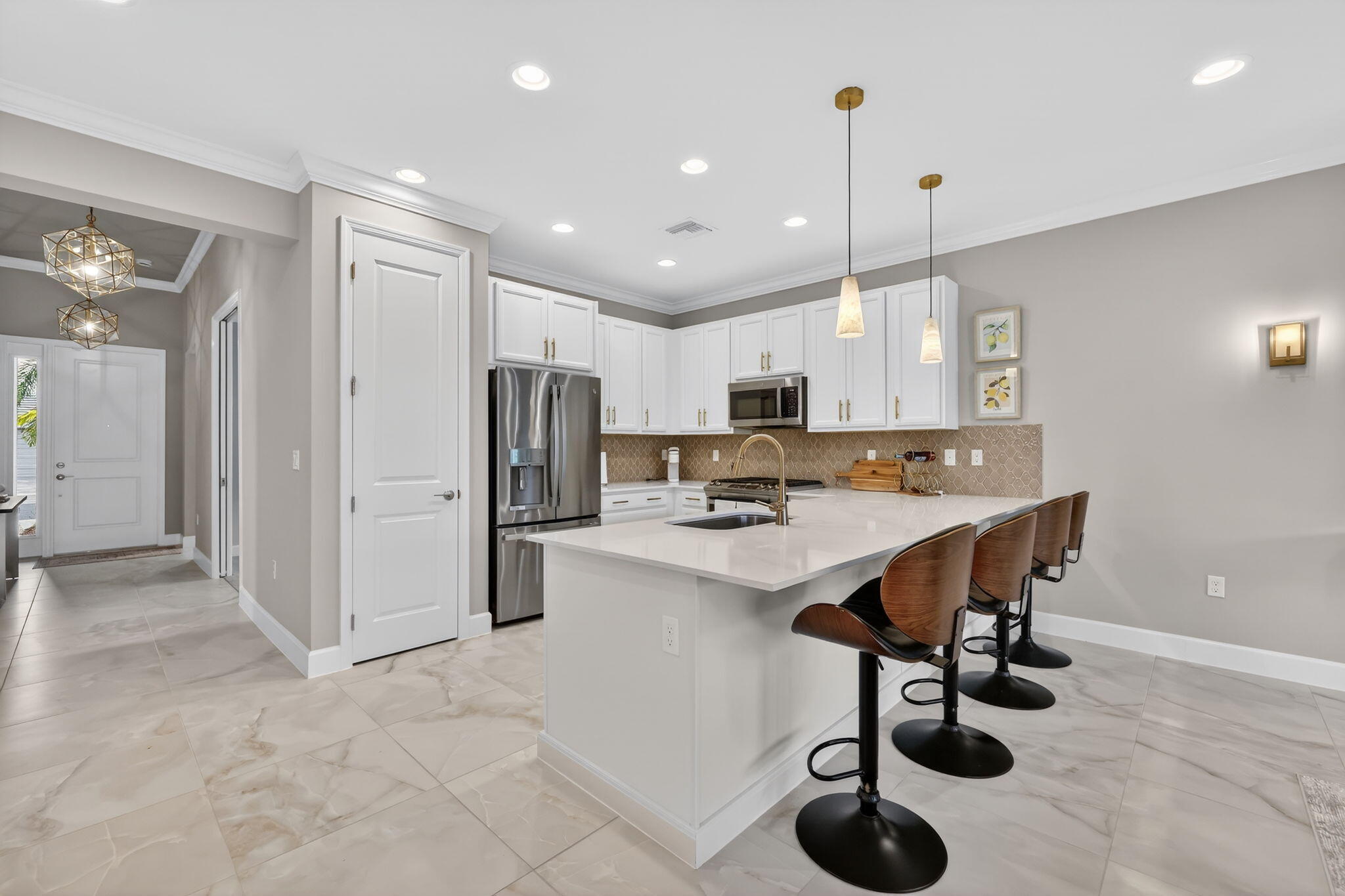 12447 Southwest Blue Mangrove Parkway Port St. Lucie, FL 34987 - Photo 8 of 80 a view of kitchen with refrigerator microwave and wooden floor