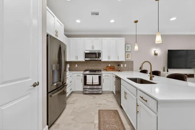 a living room with furniture and floor to ceiling windows