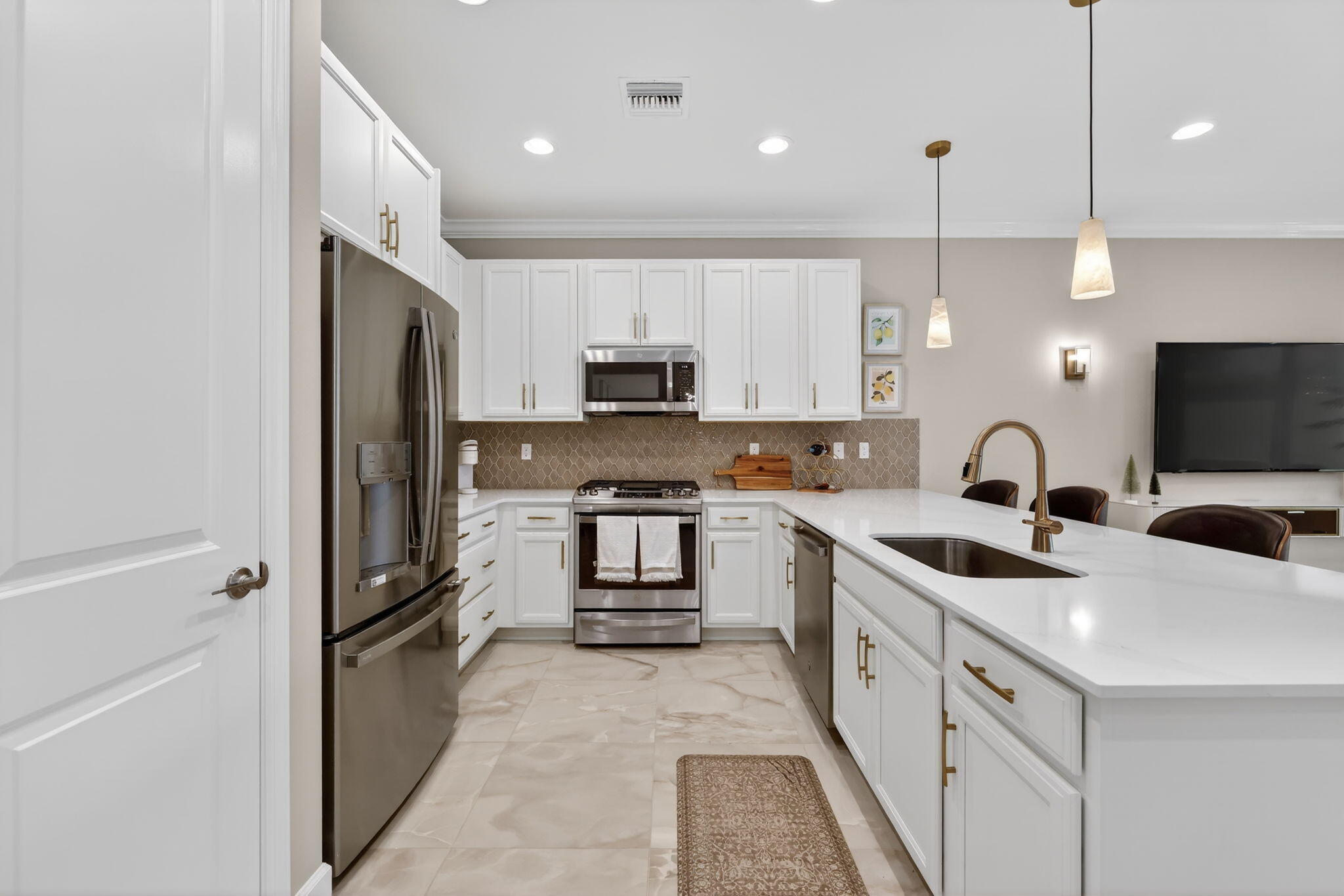 12447 Southwest Blue Mangrove Parkway Port St. Lucie, FL 34987 - Photo 9 of 80 a kitchen with a sink a counter top space stainless steel appliances and cabinets