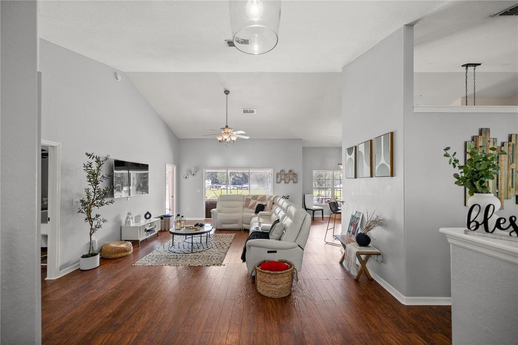13783 Southeast 8th Court Ocala, FL 34480 - Photo 12 of 47 a living room with furniture and a wooden floor