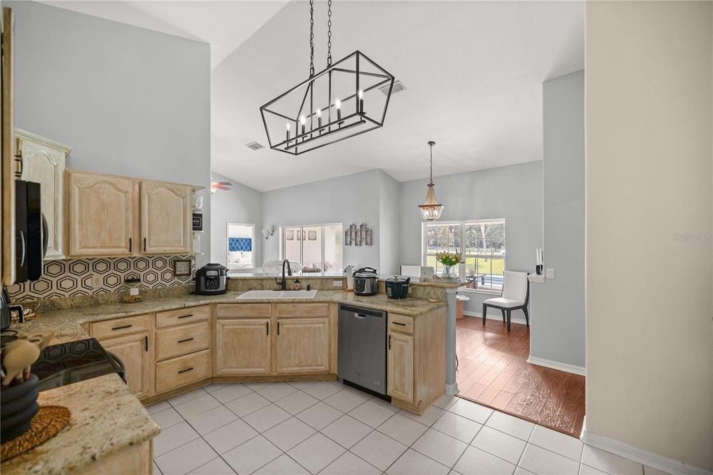 13783 Southeast 8th Court Ocala, FL 34480 - Photo 20 of 47 a kitchen with white cabinets and white appliances
