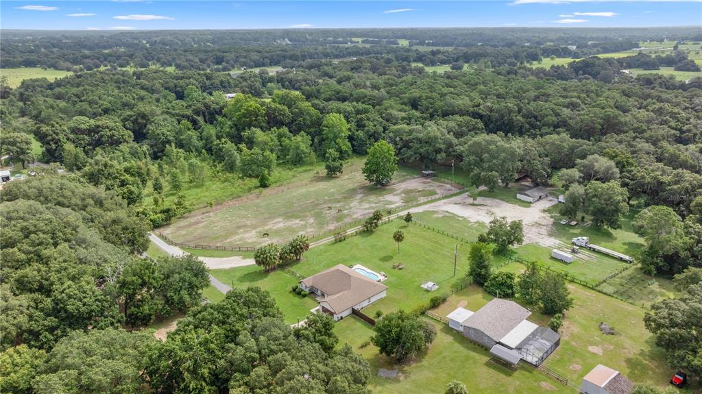 13783 Southeast 8th Court Ocala, FL 34480 - Photo 2 of 47 an aerial view of a house with a yard