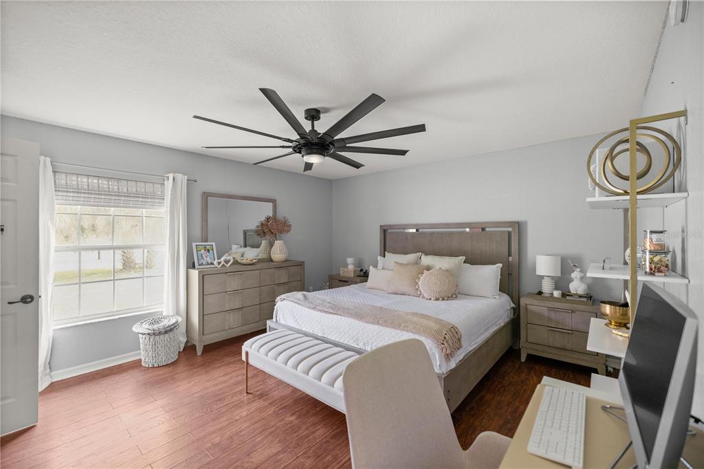 13783 Southeast 8th Court Ocala, FL 34480 - Photo 25 of 47 a bedroom with a bed and a chandelier