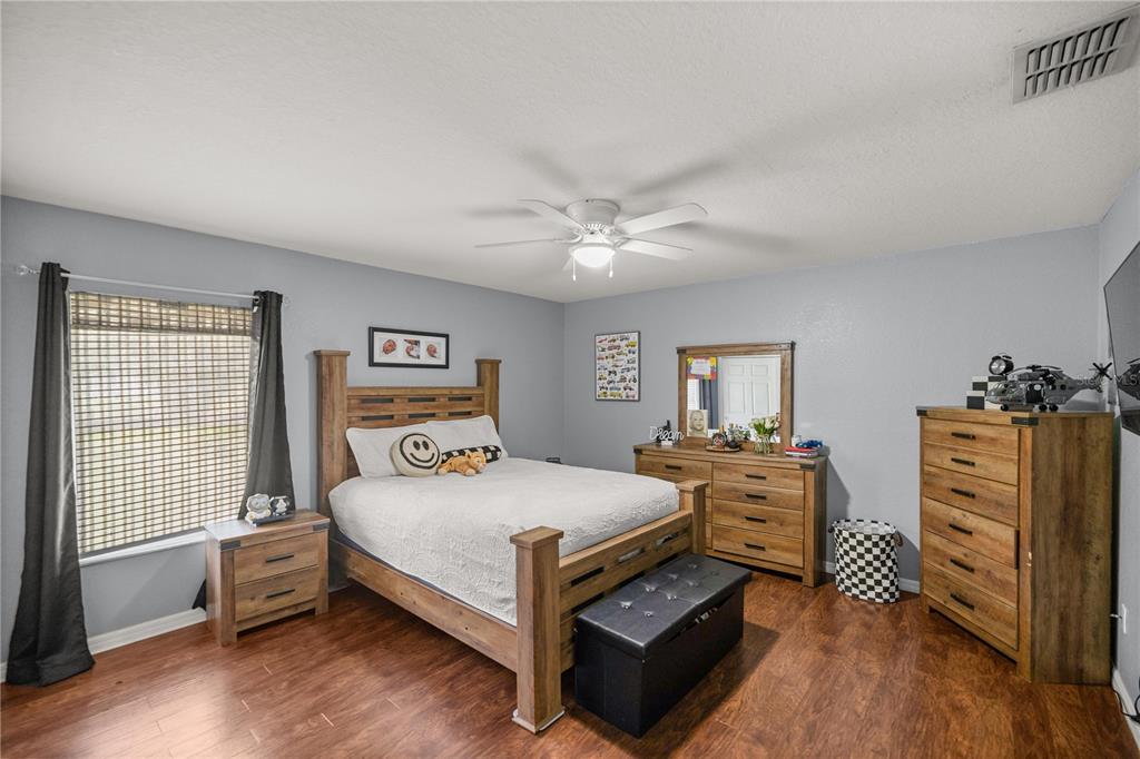 13783 Southeast 8th Court Ocala, FL 34480 - Photo 34 of 47 a bedroom with a bed and a dresser in it