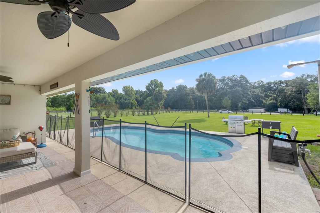 13783 Southeast 8th Court Ocala, FL 34480 - Photo 40 of 47 a view of a swimming pool and a back yard
