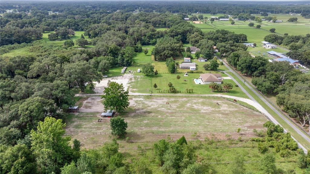 13783 Southeast 8th Court Ocala, FL 34480 - Photo 6 of 47 an aerial view of residential houses with outdoor space and trees
