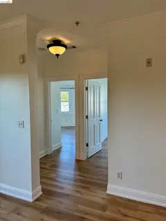 a view of a hallway with wooden floor