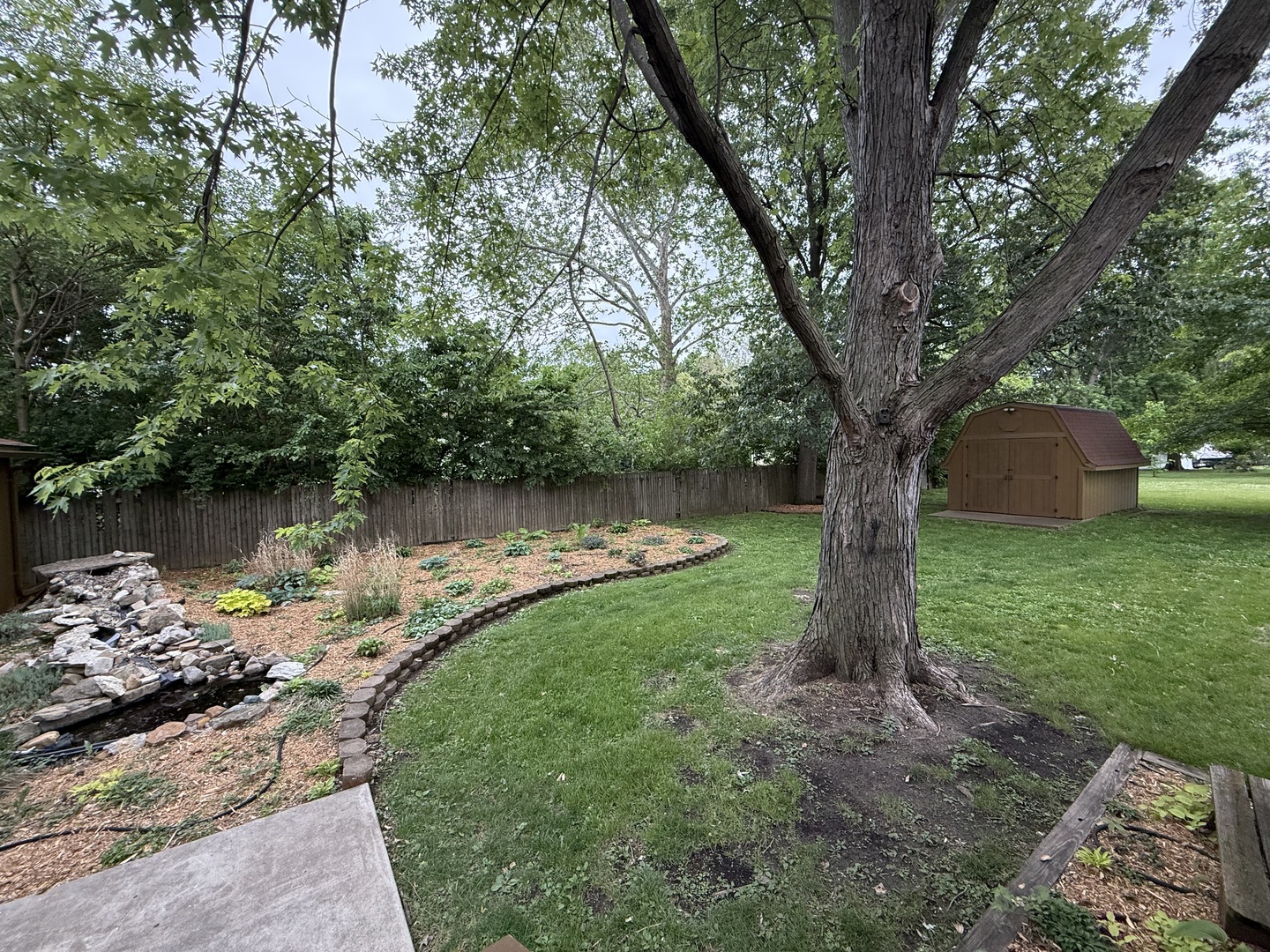 1048 Warren Street Henry, IL 61537 - Photo 25 of 26 a lake view with a sitting space and a large tree