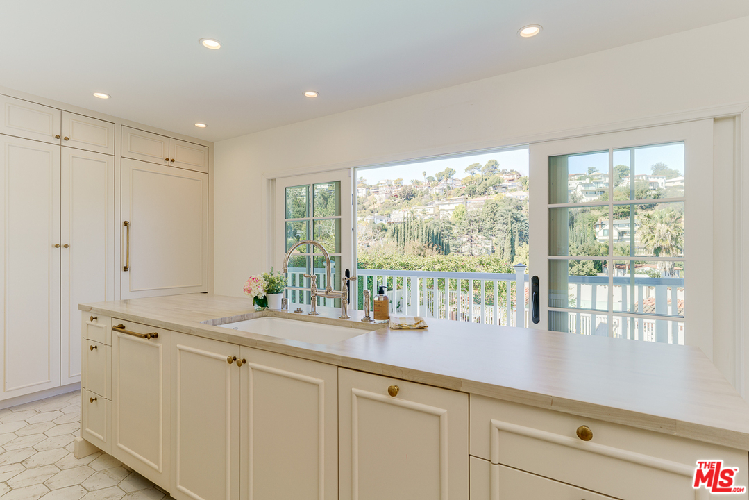 3347 Ley Drive Los Angeles, CA 90027 - Photo 21 of 54 a dining hall with stainless steel appliances granite countertop a sink and dishwasher with wooden floor