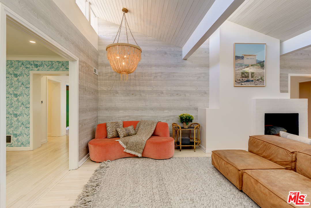 3347 Ley Drive Los Angeles, CA 90027 - Photo 27 of 54 a living room with furniture a fireplace and a chandelier