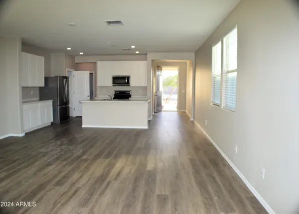 a view of kitchen with cabinets and wooden floor