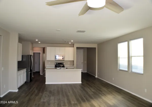 a kitchen with stainless steel appliances a refrigerator sink and microwave