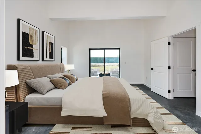 a living room with a bed furniture and next to a window