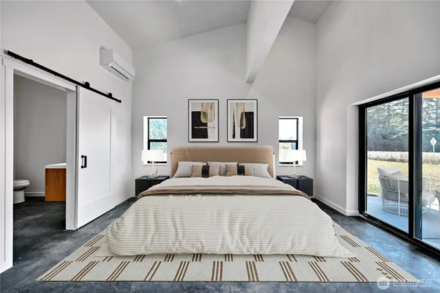 a spacious bedroom with a bed and a large mirror