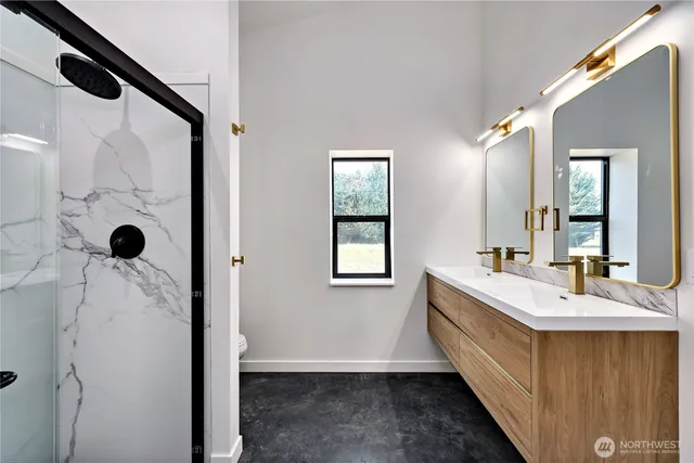 a bathroom with a double vanity sink a mirror and shower