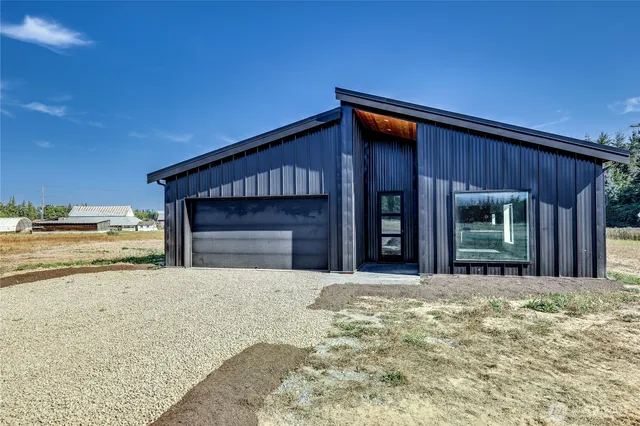 a view of a house with a yard and garage