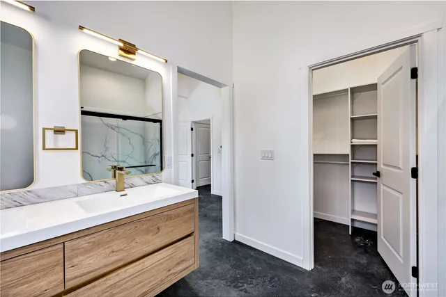 a bathroom with a double vanity sink mirror and