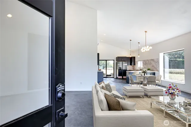 a living room with furniture a chandelier and a window