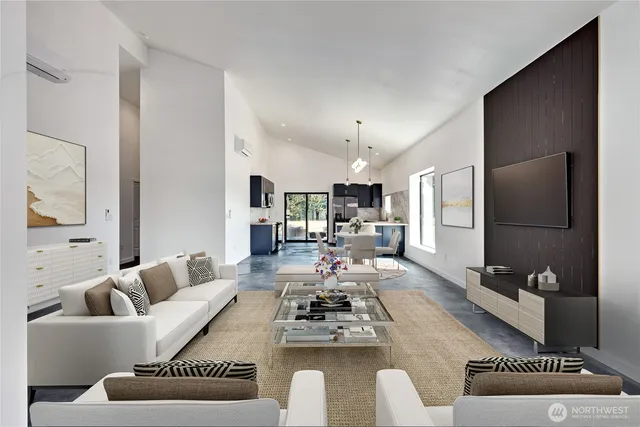 a living room with furniture a flat screen tv and kitchen view