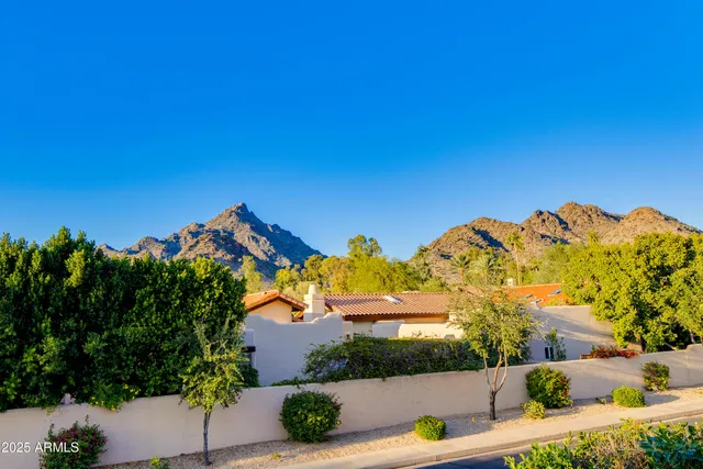a bathroom with a granite countertop double vanity sink and a mirror