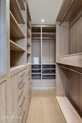 a bedroom with a bed and a mirror