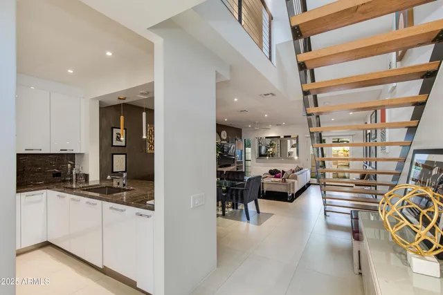 a kitchen with stainless steel appliances a refrigerator sink and microwave