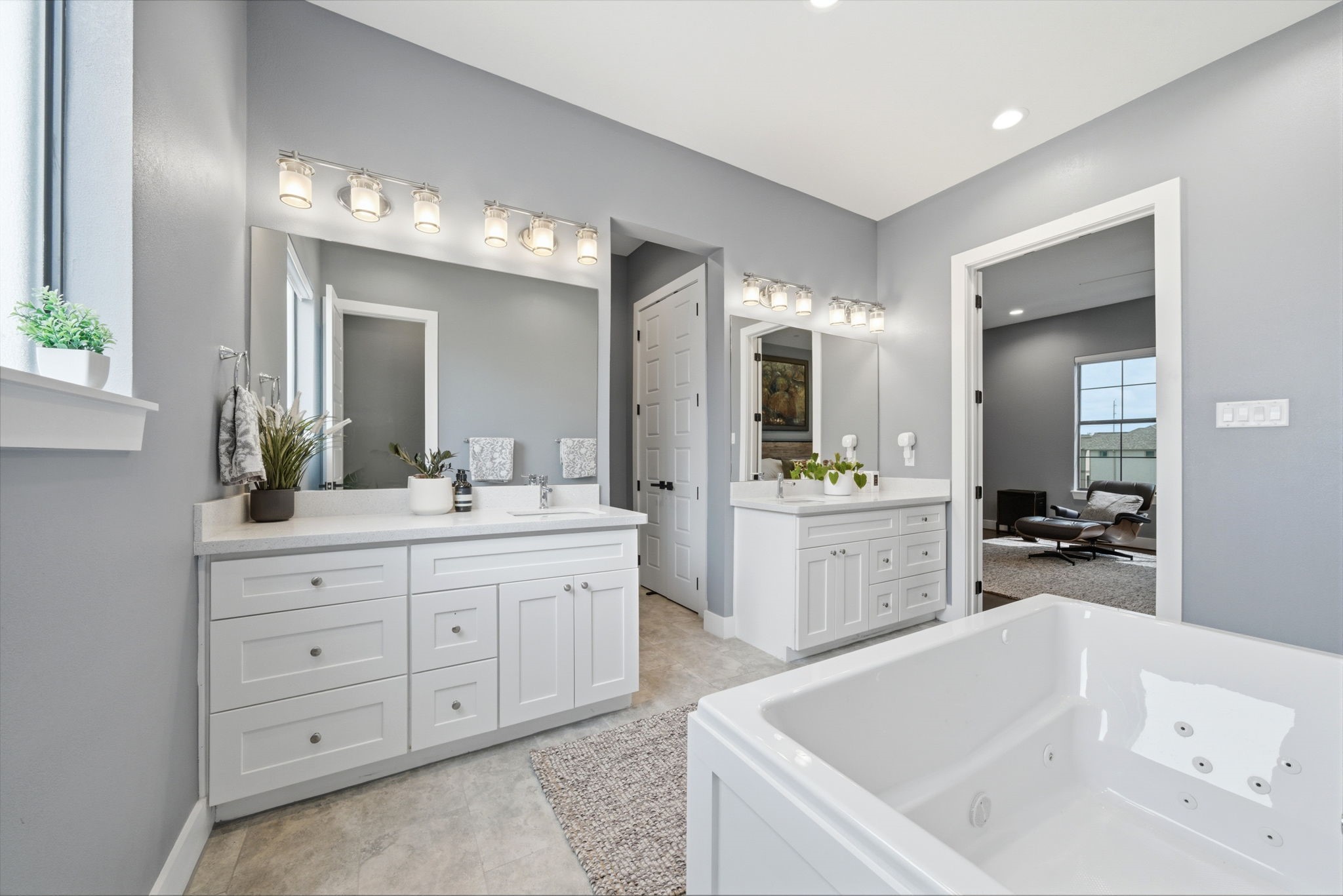 4306 Center Street Houston, TX 77007 - Photo 13 of 28 a bathroom with a tub a sink double vanity and a mirror