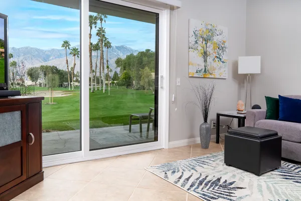 a bedroom with furniture and a floor to ceiling window
