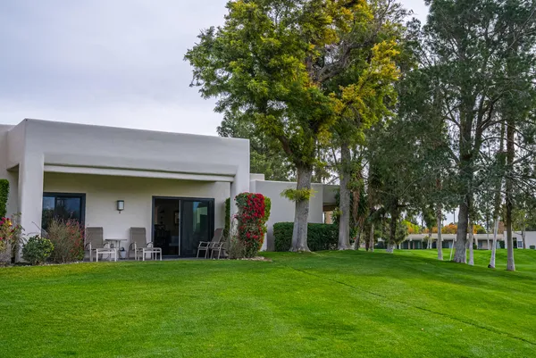 a view of a house with a backyard