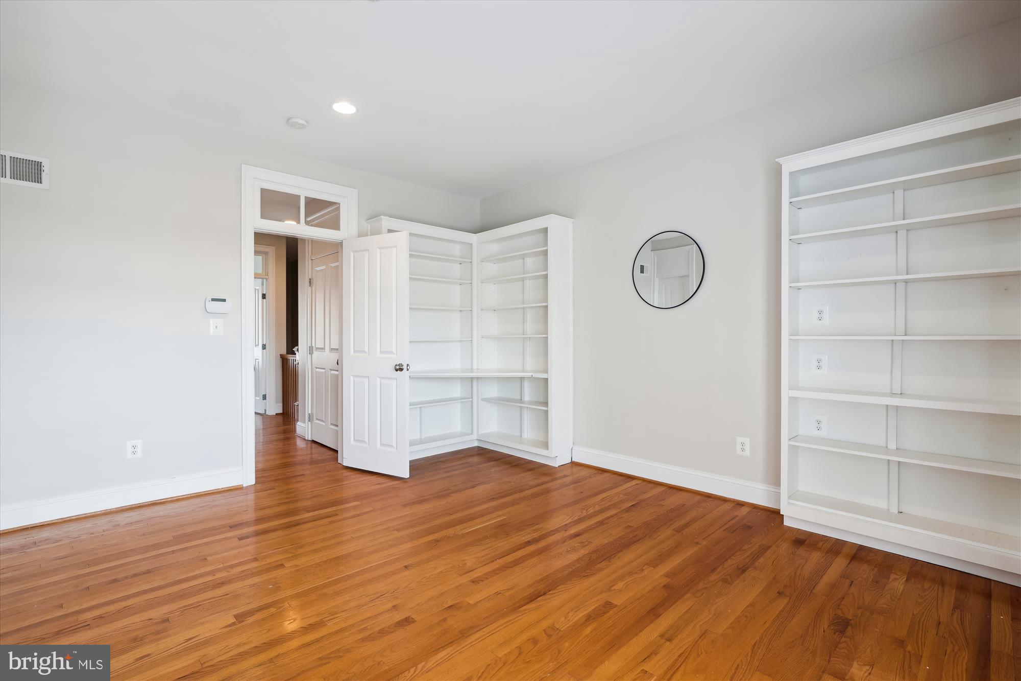 229 Locust Street Southeast, Unit 3 Vienna, VA 22180 - Photo 20 of 57 a view of empty room with wooden floor and cabinet