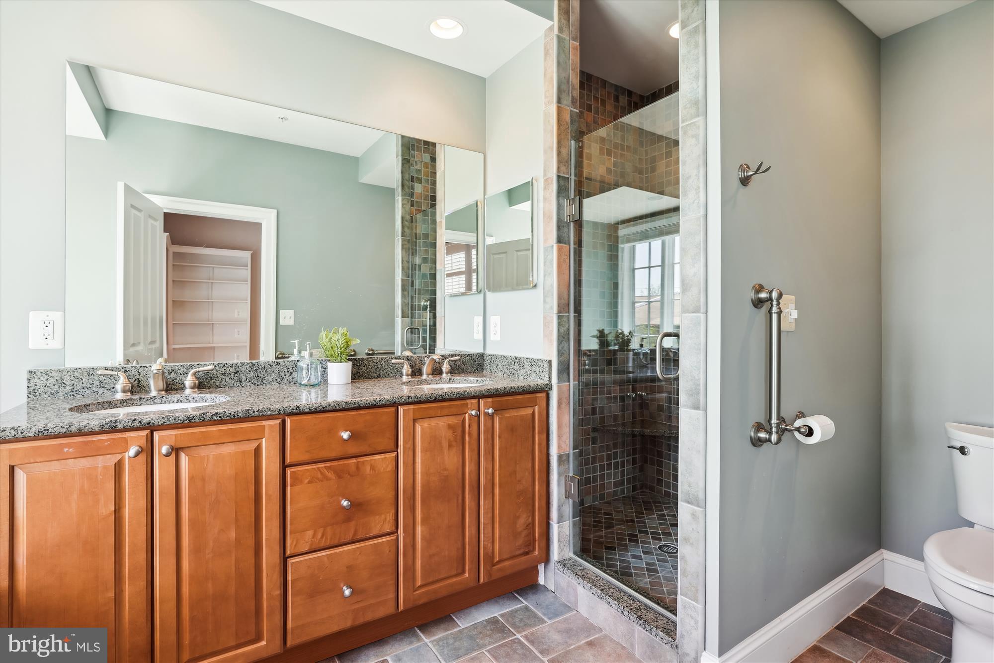 229 Locust Street Southeast, Unit 3 Vienna, VA 22180 - Photo 24 of 57 a bathroom with a granite countertop sink a mirror a vanity and a shower