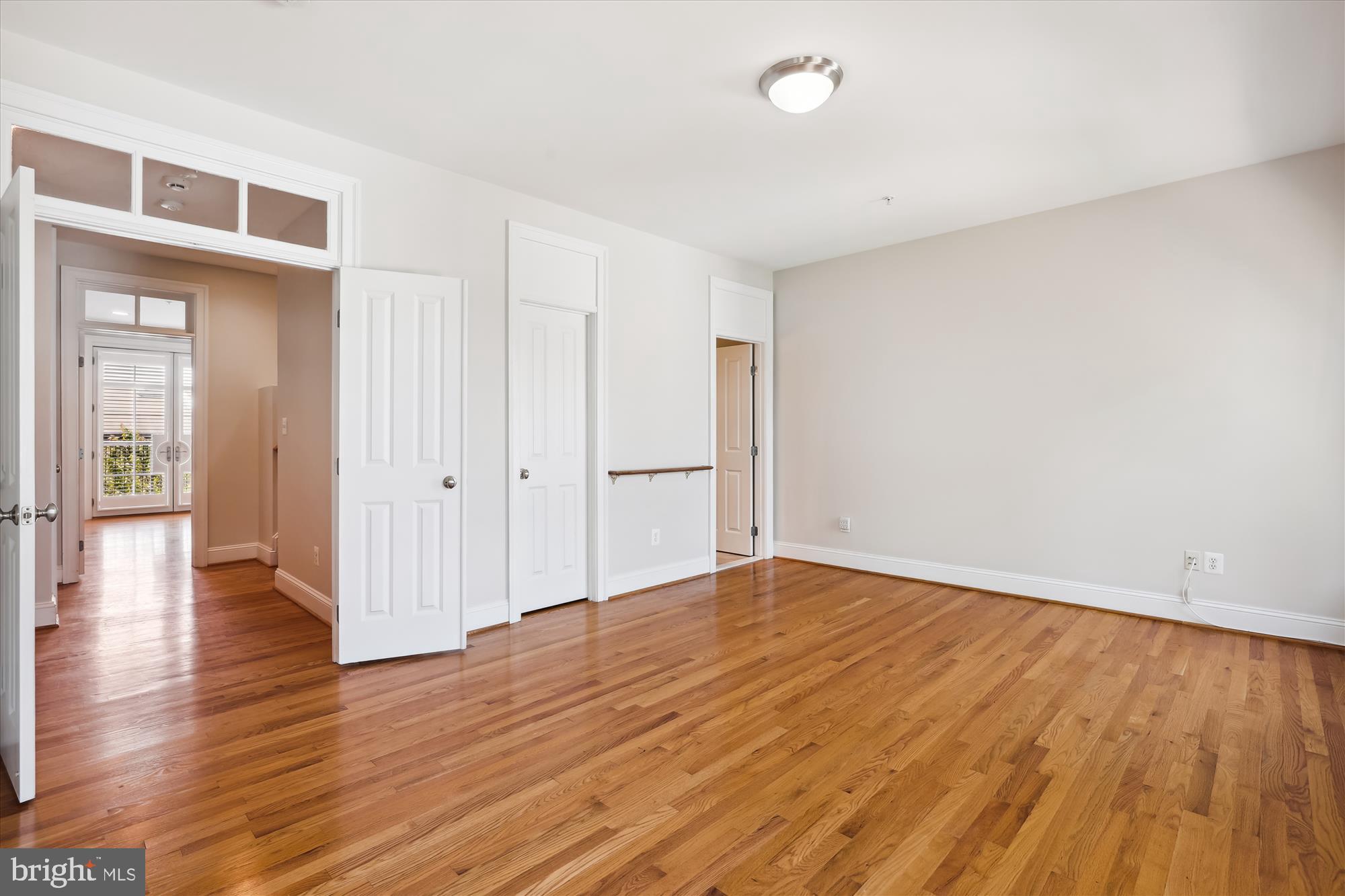 229 Locust Street Southeast, Unit 3 Vienna, VA 22180 - Photo 27 of 57 a view of an empty room with wooden floor and a window