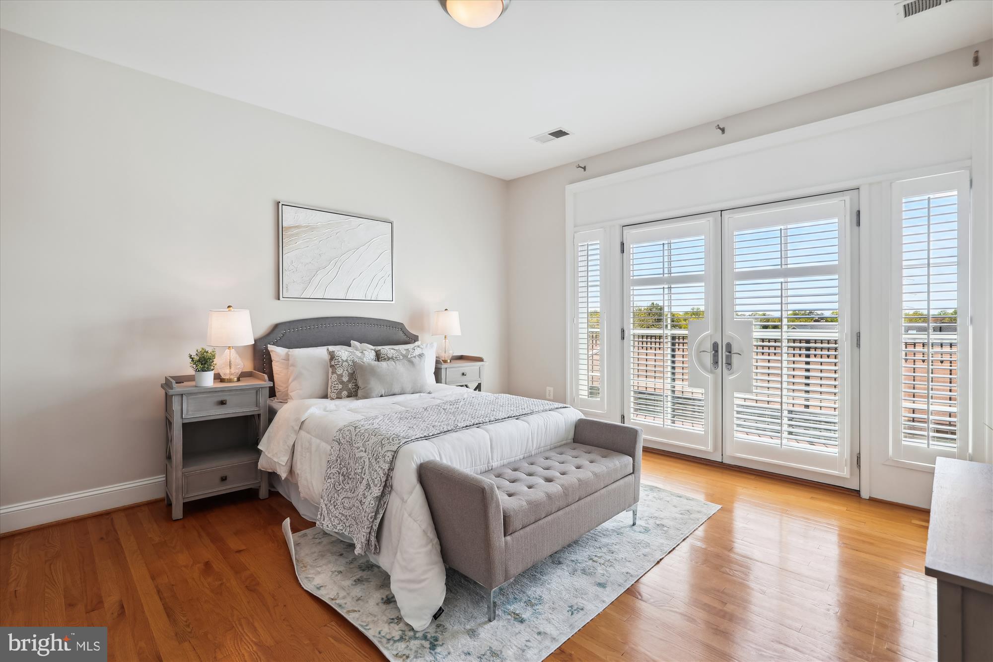 229 Locust Street Southeast, Unit 3 Vienna, VA 22180 - Photo 32 of 57 a bedroom with a bed and wooden floor