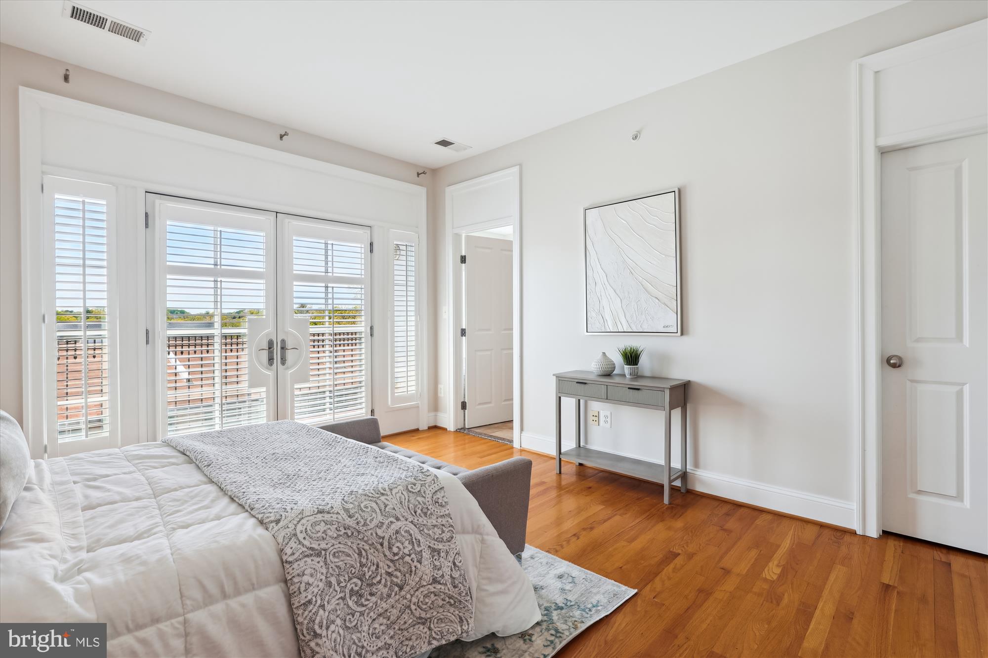 229 Locust Street Southeast, Unit 3 Vienna, VA 22180 - Photo 35 of 57 a spacious bedroom with a large bed and a wooden floor