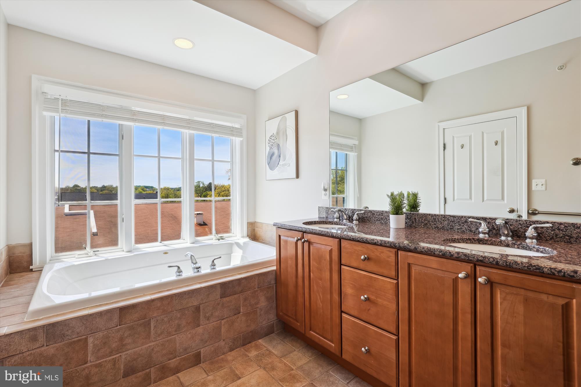 229 Locust Street Southeast, Unit 3 Vienna, VA 22180 - Photo 36 of 57 a bathroom with a granite countertop tub sink and mirror