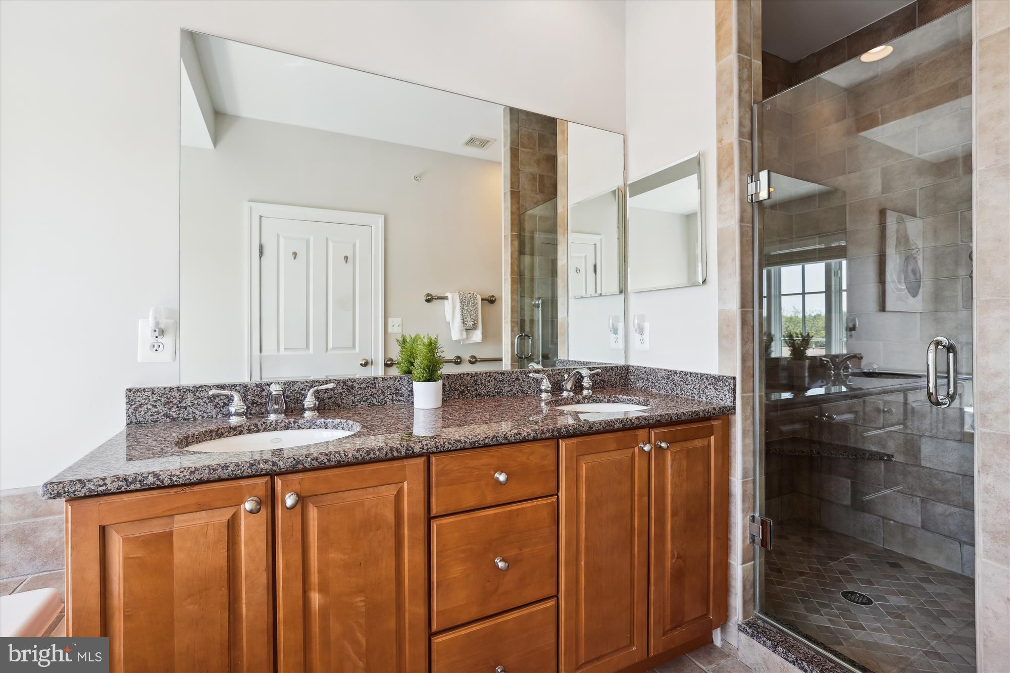 229 Locust Street Southeast, Unit 3 Vienna, VA 22180 - Photo 37 of 57 a bathroom with a granite countertop sink and a mirror