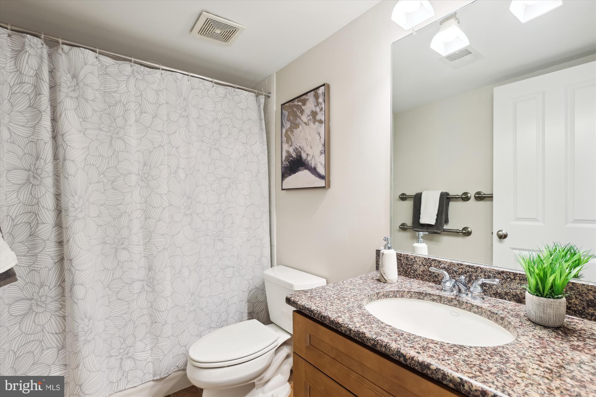 229 Locust Street Southeast, Unit 3 Vienna, VA 22180 - Photo 48 of 57 a bathroom with a granite countertop sink a toilet and a mirror