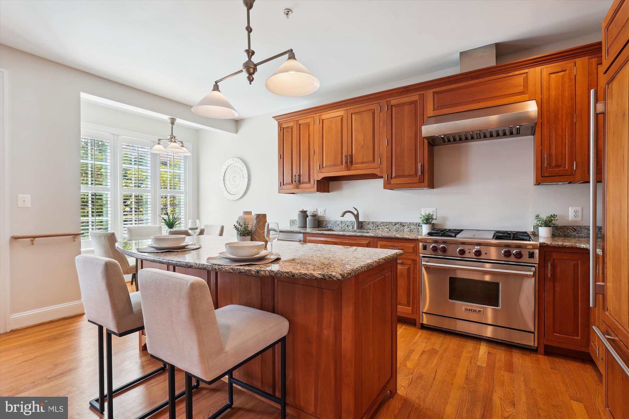 229 Locust Street Southeast, Unit 3 Vienna, VA 22180 - Photo 9 of 57 a kitchen with stainless steel appliances granite countertop a stove a sink dishwasher and a stove with wooden floors
