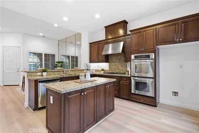 a kitchen with a sink stove and refrigerator