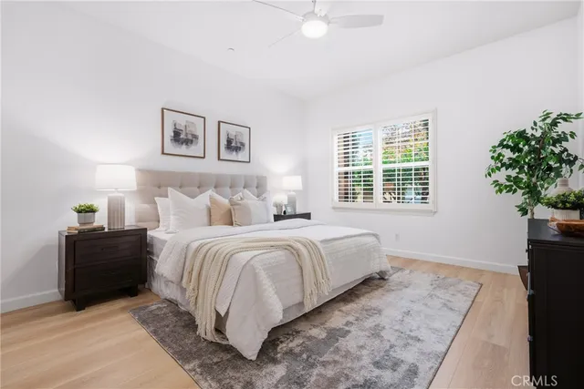 a bedroom with a bed and a potted plant