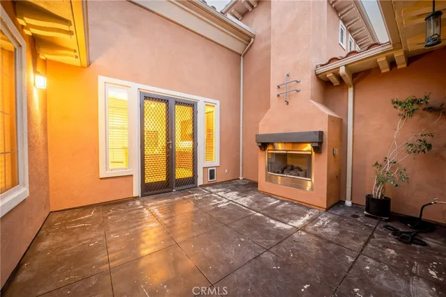 a view of an empty room with a fireplace and a window