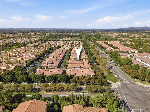 an aerial view of residential building and car parked on street side